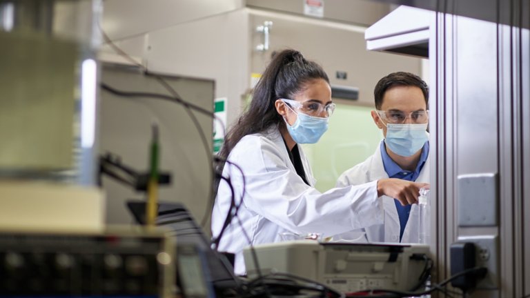 Man and woman working within a facility