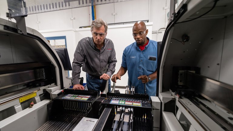 Two Rockwell Automation employees in the Twinsburg Ohio facility viewing a machine in operation
